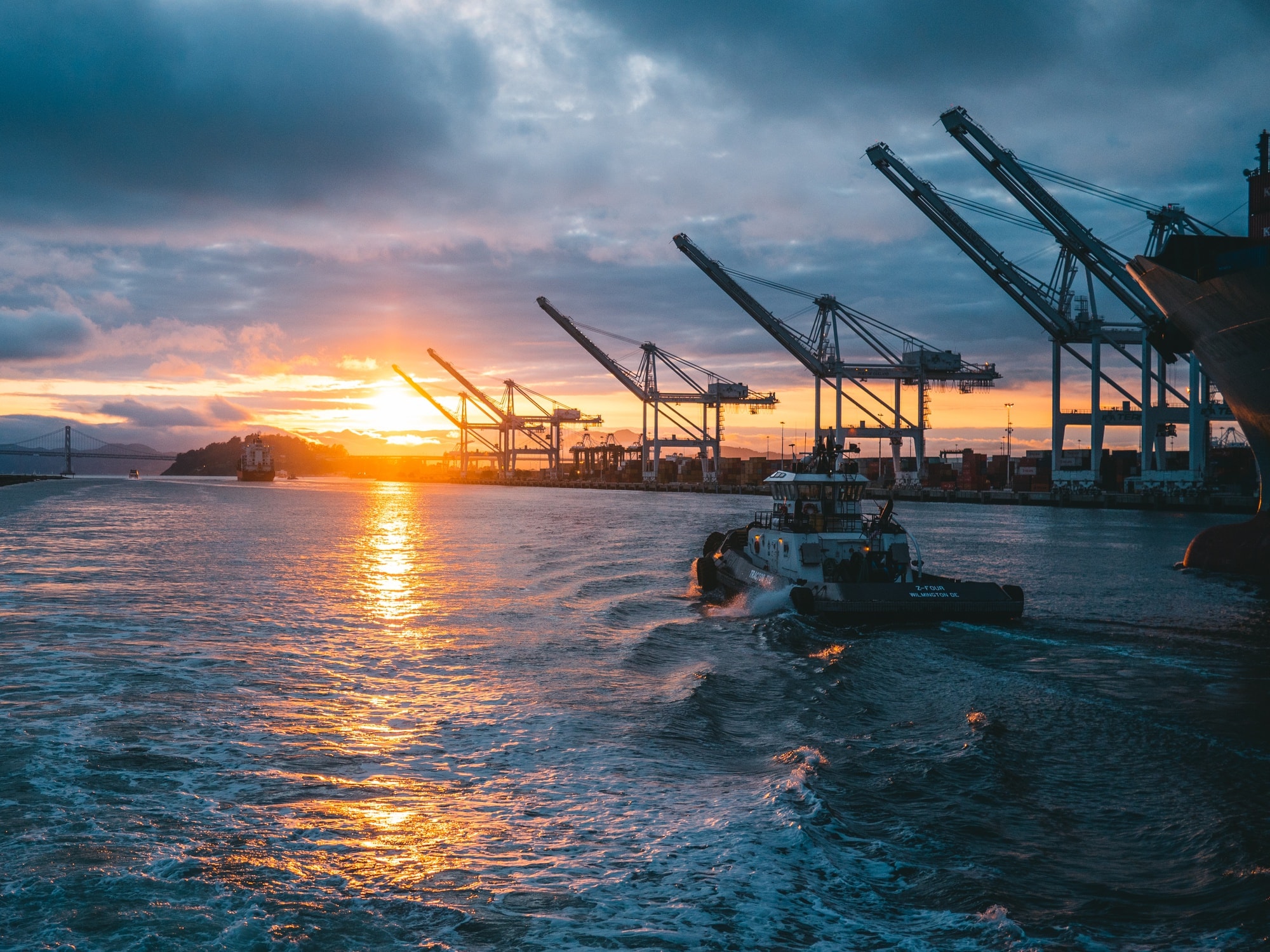 Port cranes and maritime infrastructure at sunset